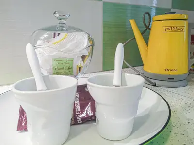 two white cups sitting on a plate on a table at Casaulente in Alcamo