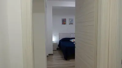 a door leading into a bedroom with a bed at Stella di Mare in Balestrate