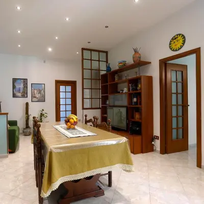 a dining room with a table with fruit on it at Biddizzi Apartment in Palermo