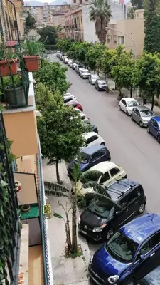 a row of cars parked on the side of a street at Biddizzi Apartment in Palermo