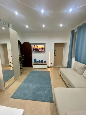 a living room with a couch and a tv at Marechiaro Apartments in Palermo