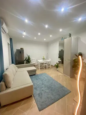 a living room with a couch and a table at Marechiaro Apartments in Palermo