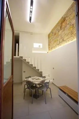 a dining room with a table and chairs and stairs at Francesco's Home Palermo in Palermo