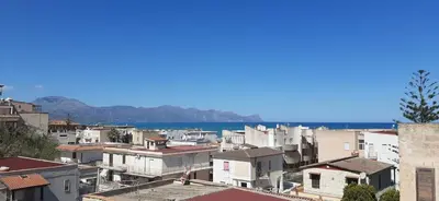 a city with buildings and the ocean in the background at Spiaggia Libera e di Sabbia dorata per 