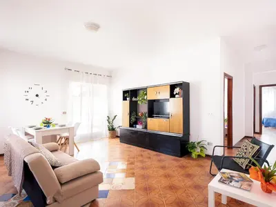 a living room with a couch and a tv at Spiaggia Libera e di Sabbia dorata per 