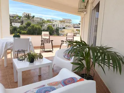 a balcony with white furniture and a table and chairs at Spiaggia Libera e di Sabbia dorata per 