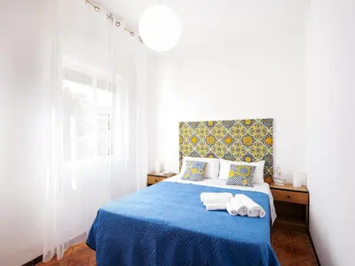 a bedroom with a blue bed with towels on it at Spiaggia Libera e di Sabbia dorata per 