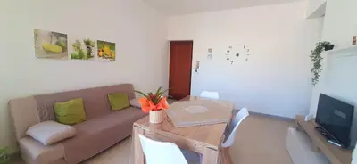 a living room with a couch and a table at Dove il mare incontra il Relax!Ampio appartamento Conchiglia Home in Alcamo Marina