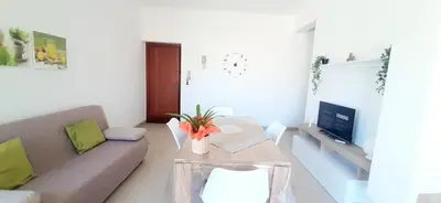 a living room with a couch and a table at Dove il mare incontra il Relax!Ampio appartamento Conchiglia Home in Alcamo Marina