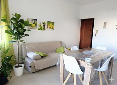 a living room with a table and a couch at Dove il mare incontra il Relax!Ampio appartamento Conchiglia Home in Alcamo Marina