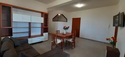 a living room with a table and a couch at Casa vacanza Luisa in Alcamo Marina