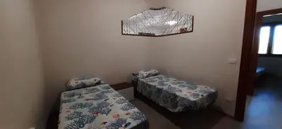 a bedroom with two beds and a basketball hoop at Casa vacanza Luisa in Alcamo Marina