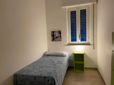 a small bedroom with a bed and a window at Grande Sole Siciliano in Palermo