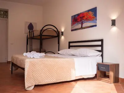 a bedroom with a bed and a bunk bed with white sheets at Aliva apartment LT in Palermo