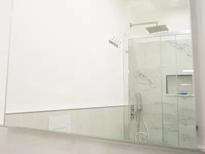 a shower with a glass door in a bathroom at Aliva apartment LT in Palermo