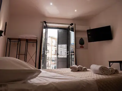 a bedroom with a bed with towels on it at Aliva apartment LT in Palermo
