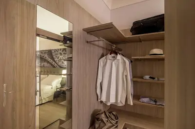 a closet with a white shirt hanging on a door at Hotel Federico II Central Palace in Palermo