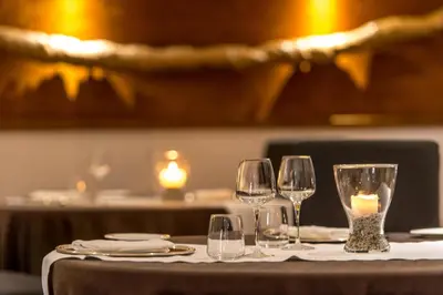 a table with wine glasses and a candle on it at Hotel Federico II Central Palace in Palermo