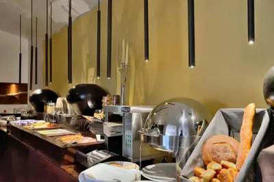 a buffet line with bread and pastries in a restaurant at Hotel Federico II Central Palace in Palermo