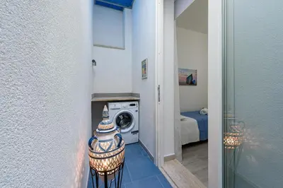 a laundry room with a washer and a washing machine at CoralBay San Vito lo Capo - Appartamento in San Vito lo Capo