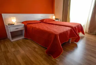 a bedroom with a bed with a red blanket at Locanda Scirocco in Castellammare del Golfo