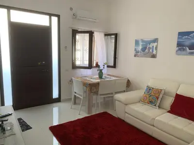 a living room with a couch and a table at Casa Enza Partanna Mondello in Palermo