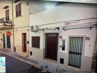 a building with doors on the side of a street at Casa Enza Partanna Mondello in Palermo