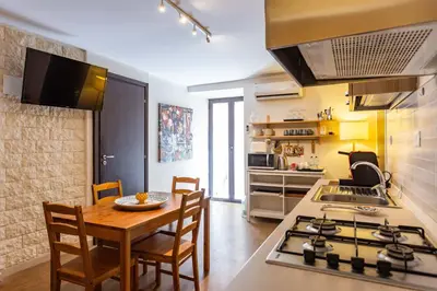 a kitchen with a table and a stove top oven at Casa Carolino in Palermo