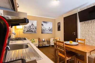 a kitchen with a sink and a kitchen table with a kitchen gmaxwell gmaxwell gmaxwell gmaxwell at Casa Carolino in Palermo