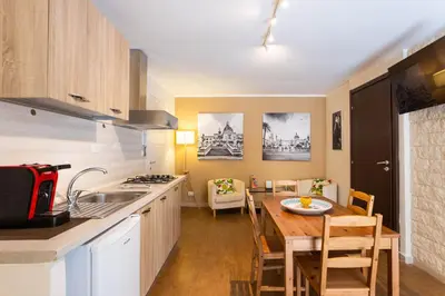 a kitchen with a table and a dining room at Casa Carolino in Palermo