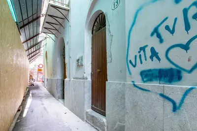 an alley with graffiti on the side of a building at GuestHost - Ballarò Central Cozy Studio with Balcony in Palermo