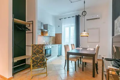a kitchen and dining room with a table and chairs at GuestHost - Ballarò Central Cozy Studio with Balcony in Palermo