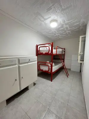 a room with a red bunk bed in a kitchen at Harin House Casa vacanze in Palermo
