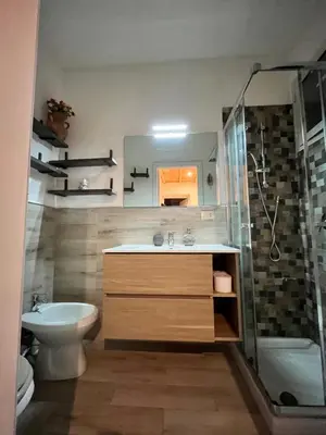 a bathroom with a sink and a shower and a toilet at Harin House Casa vacanze in Palermo