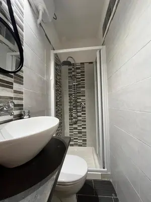 a bathroom with a sink and a toilet and a shower at Harin House Casa vacanze in Palermo