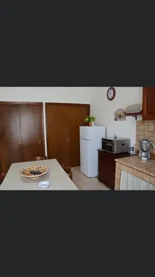 a kitchen with a table with a plate on a counter at Vacanze Da Laura in San Vito lo Capo