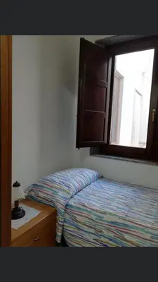 a small bedroom with a bed and a window at Vacanze Da Laura in San Vito lo Capo