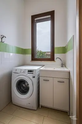 a laundry room with a washing machine and a sink at Villa DellOmbra in Alcamo
