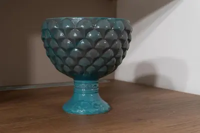 a green glass vase sitting on a table at Vittorio Emanuele Charming Central Flats in Palermo