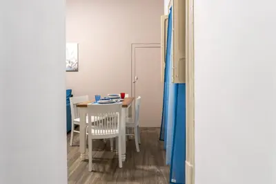 a small white table and chairs in a room at Vittorio Emanuele Charming Central Flats in Palermo