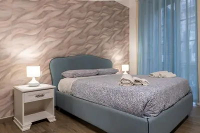 a bedroom with a blue bed with a wooden wall at Vittorio Emanuele Charming Central Flats in Palermo