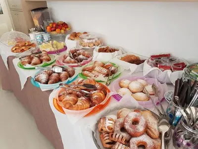 a table with many different types of pastries on it at Hotel Sikania in San Vito lo Capo
