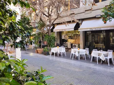 a group of tables and chairs in front of a store at Palermo Amari in Palermo