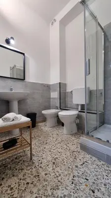 a bathroom with two toilets and a sink and a shower at Palermo Amari in Palermo