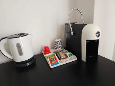 a coffee maker and a coffeemaker sitting on a table at Palermo Amari in Palermo