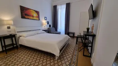 a hotel room with a bed and a television at Palermo Amari in Palermo