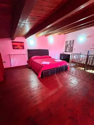 a bedroom with a bed in a room with pink walls at Antica Locanda Zio Cesare MONTELEPRE in Montelepre