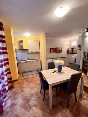 a kitchen and dining room with a table and chairs at Antica Locanda Zio Cesare MONTELEPRE in Montelepre
