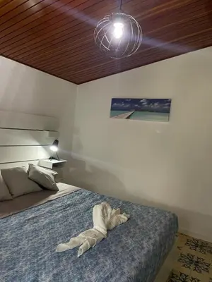 a bedroom with a bed with a towel on it at The White Sail - Mondello Apartment with Terrace - casa di vincenzo e andrea in Mondello