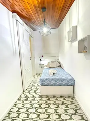a bedroom with a bed with a wooden ceiling at The White Sail - Mondello Apartment with Terrace - casa di vincenzo e andrea in Mondello